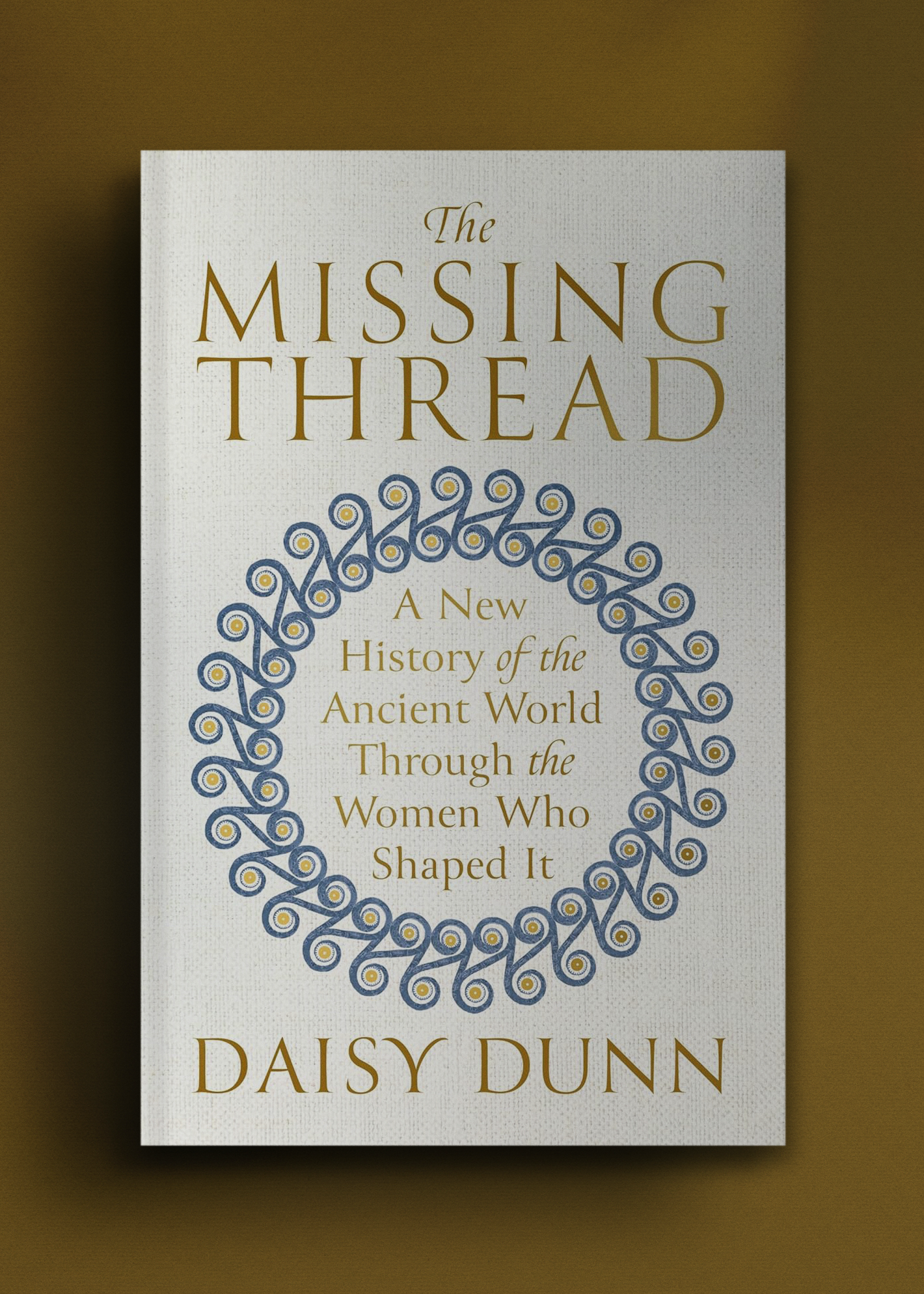 Cover of "The Missing Thread" by Daisy Dunn, features title and subtitle in gold on a light background with a decorative blue spiral motif.